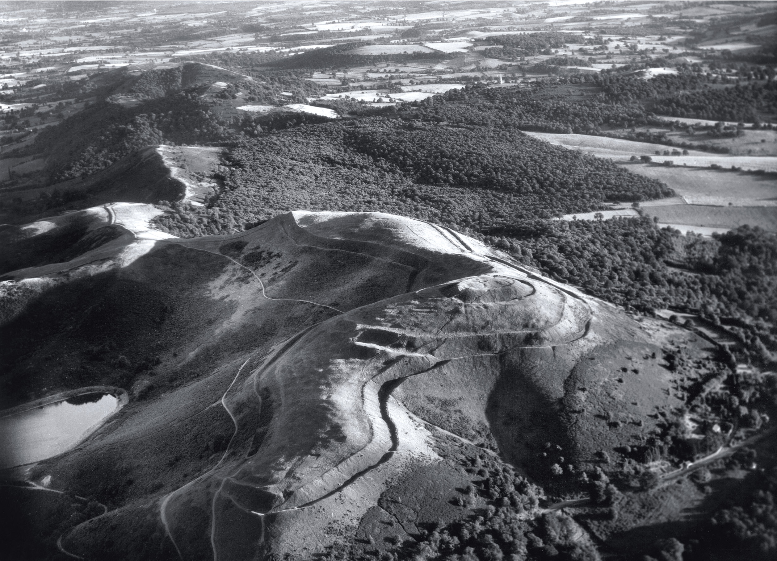 above One of Harold Wingham’s soaring archaeological views: this photograph shows British Camp, near Colwall, also known as Herefordshire Beacon Camp. There, excavations have found Iron Age and Roman pottery, medieval structures, and a 10th-century golden coronet.