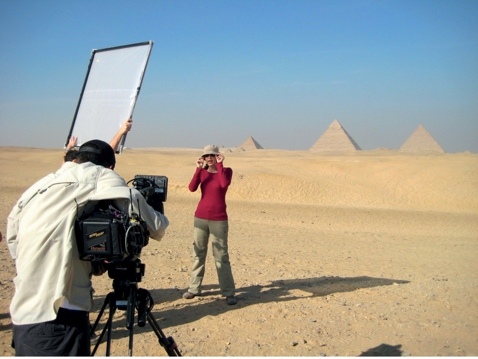 1. Kara Cooney filming Out of Egypt for Discovery Channel. She is on the edge of the desert with the three Pyramids of Giza in the background. © Discovery Communications. 2. A face for television with eyes on the past. Photograph by Mikel Healey.
