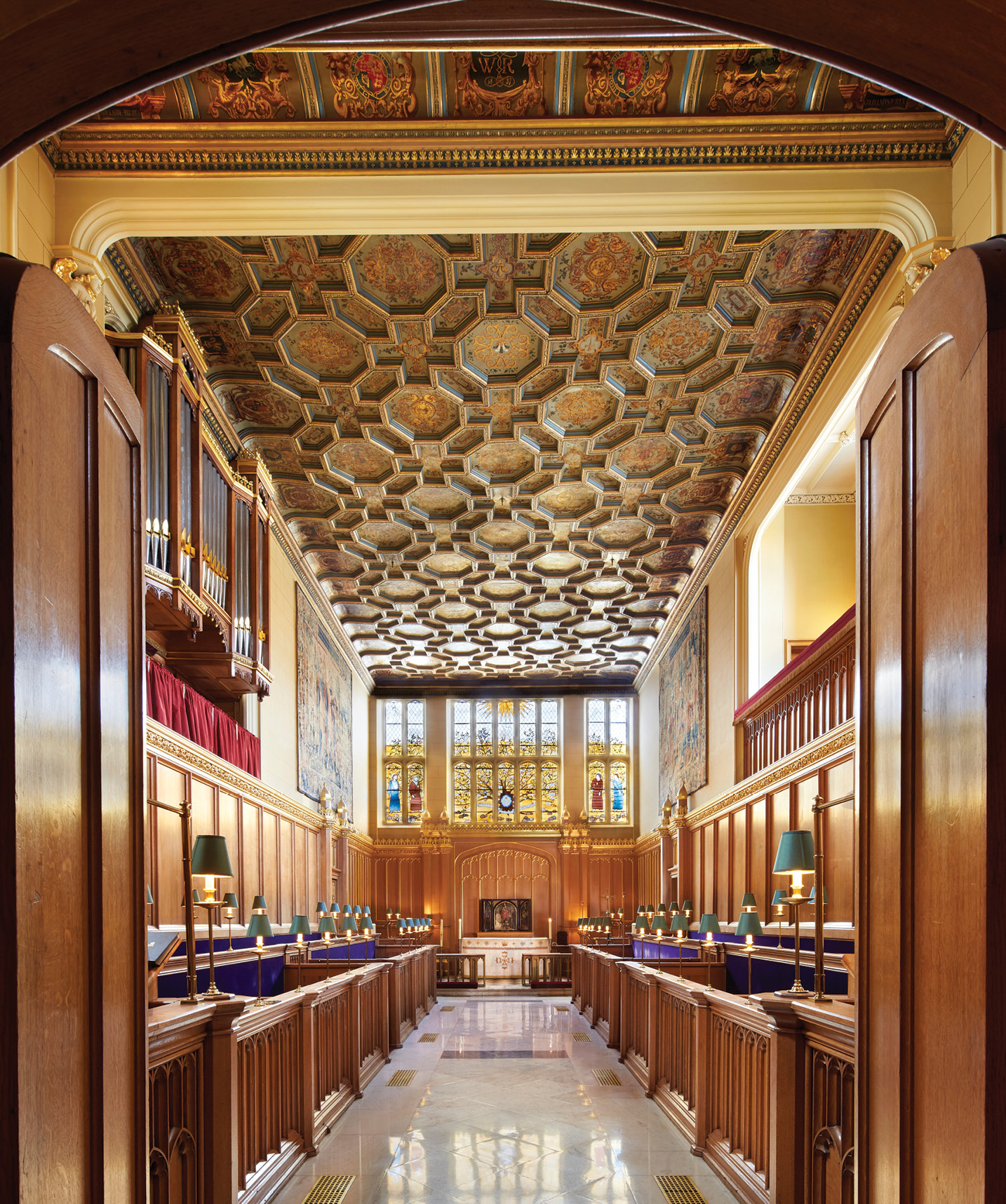 below The Chapel Royal, looking north (ecclesiastical east), showing the Tudor ceiling and the stained-glass window, designed for the Queen’s Golden Jubilee in 2002, which depicts a tree bearing the names of the Commonwealth nations.