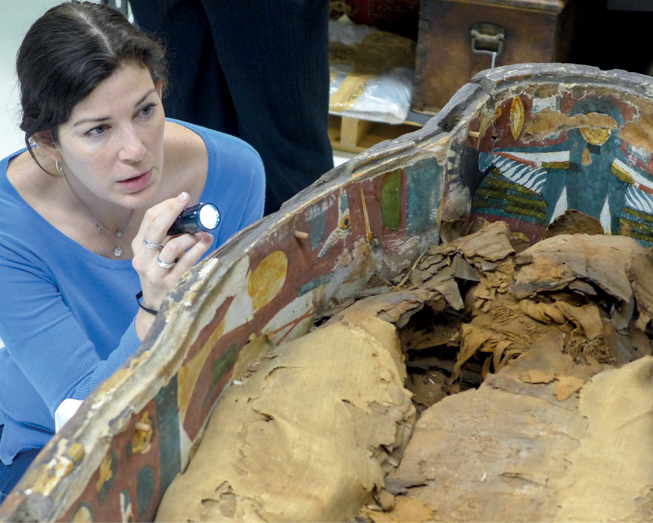 3. Kara examining a coffin for traces of re-use in the National Museum of Scotland in Edinburgh in 2014.Photograph by Marissa Stevens. 4. In Edinburgh, Kara inspects the decorated lid of another coffin, containing a female mummy from the 21st Dynasty; again she is looking for signs of re-use. Photograph by Marissa Stevens.