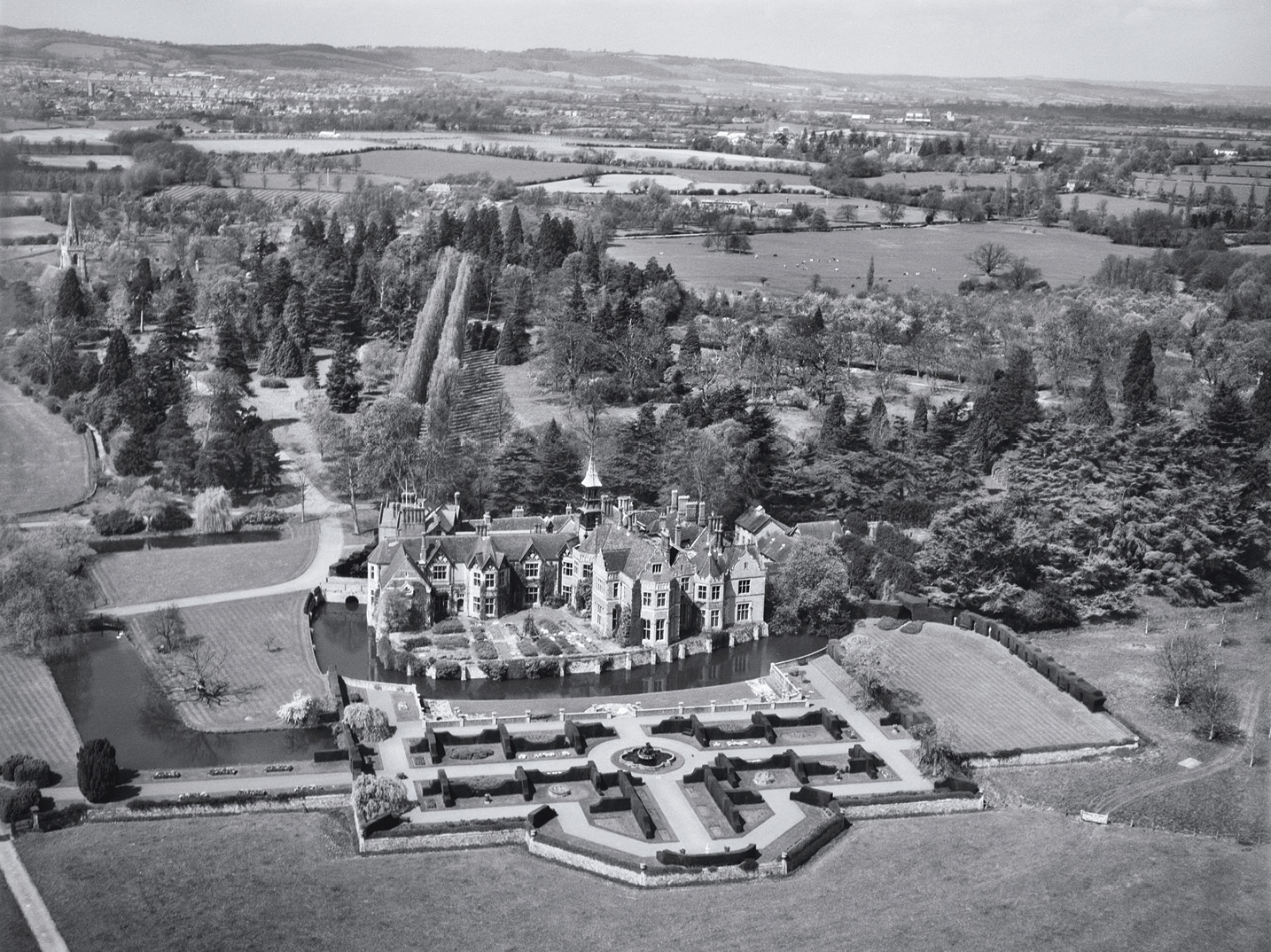 below Madresfield Court, Worcestershire. This country house dates to the 16th century but was extensively restored, rebuilt, and extended in 1866-1888; it was often visited by Evelyn Waugh and inspired aspects of his novel Brideshead Revisited.