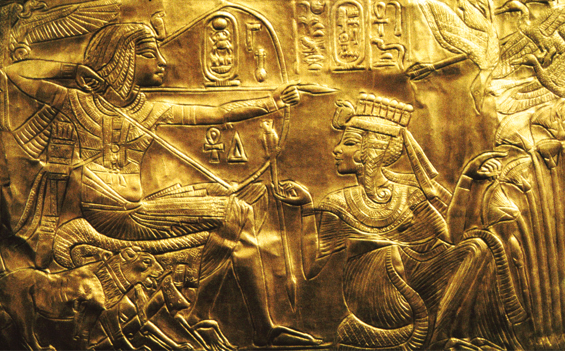 above A scene from the small golden shrine found in Tutankhamun’s tomb, showing the king sitting down to use his bow and arrow, while his sister-wife Ankhesenamun sits at his feet.