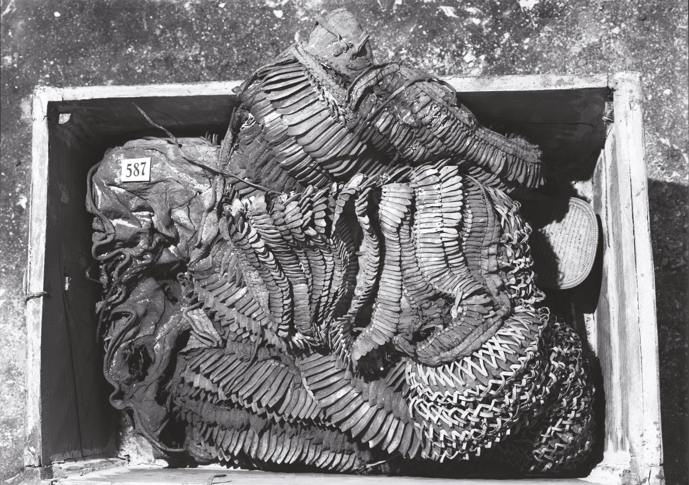 TOP A suit of leather armour possibly worn by Tutankhamun. Recent examination revealed signs of wear. above A decorated bow case and composite bow from the tomb of Tutankhamun.