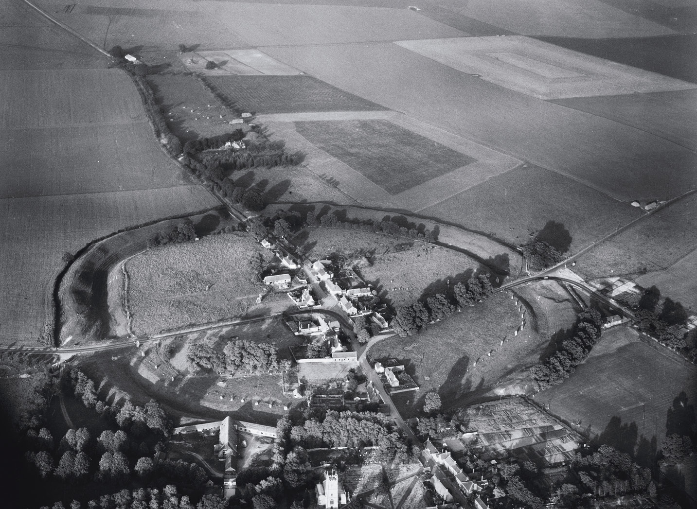 right This photograph, taken on 9 July 1958, shows the village of Avebury in Wiltshire. It includes the Neolithic henge enclosure that forms part of the Avebury and Stonehenge World Heritage Site. below right A similarly circular but rather less ancient subject: HMP Dartmoor, photographed on 23 July 1959. Initially built to house prisoners of war in the early 19th century, it was converted into a civilian prison in 1850. Note the uniquely shaped football pitch within its bounds.