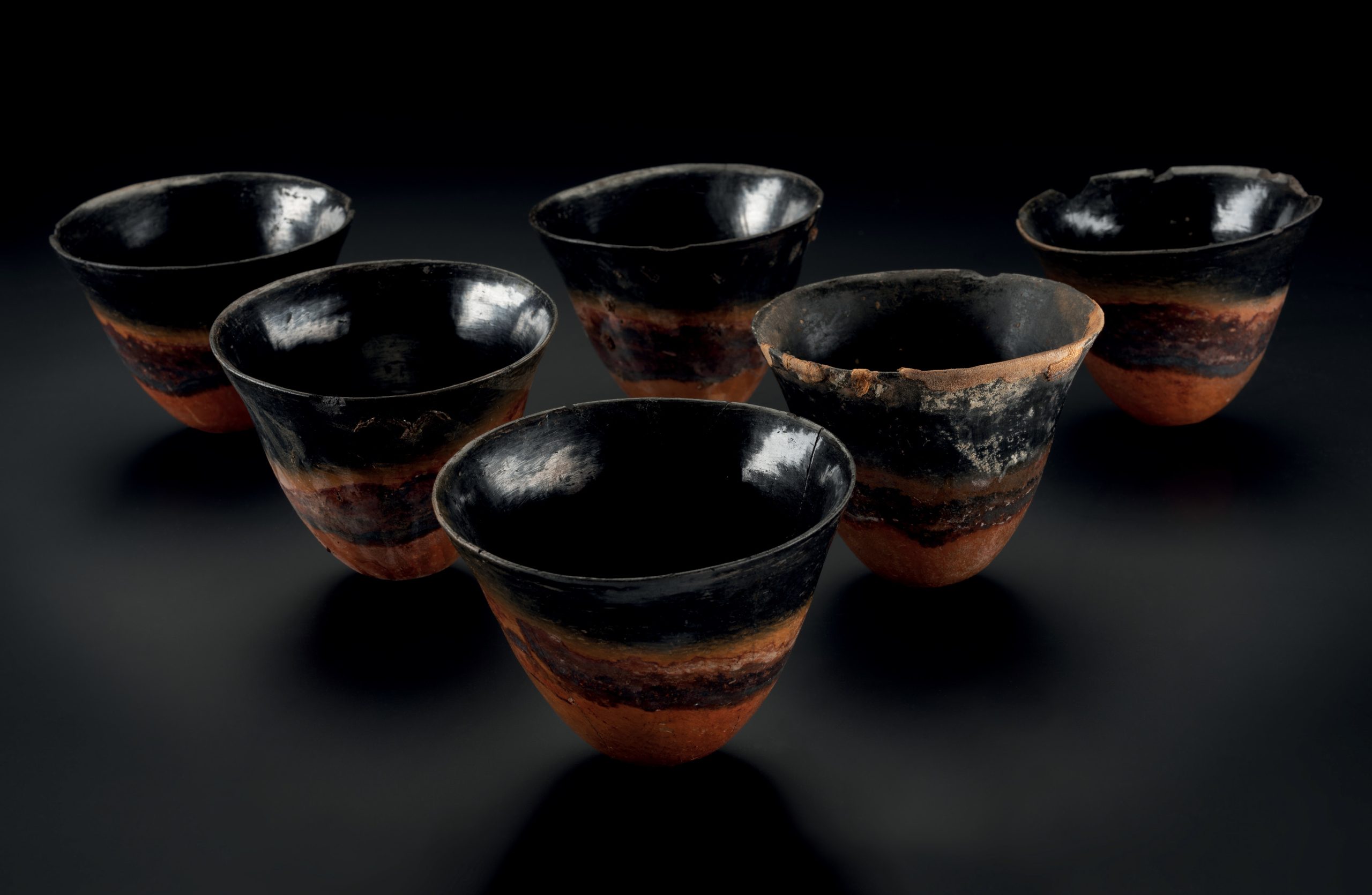 ABOVE These six Kerma beakers from Nubia were found in the Qurna Burial. Far left The huge temple at the centre of the city of Kerma, known as the Western Deffufa. Left A bowl with a painted black rim filled with dates, grapes, and possibly peaches.