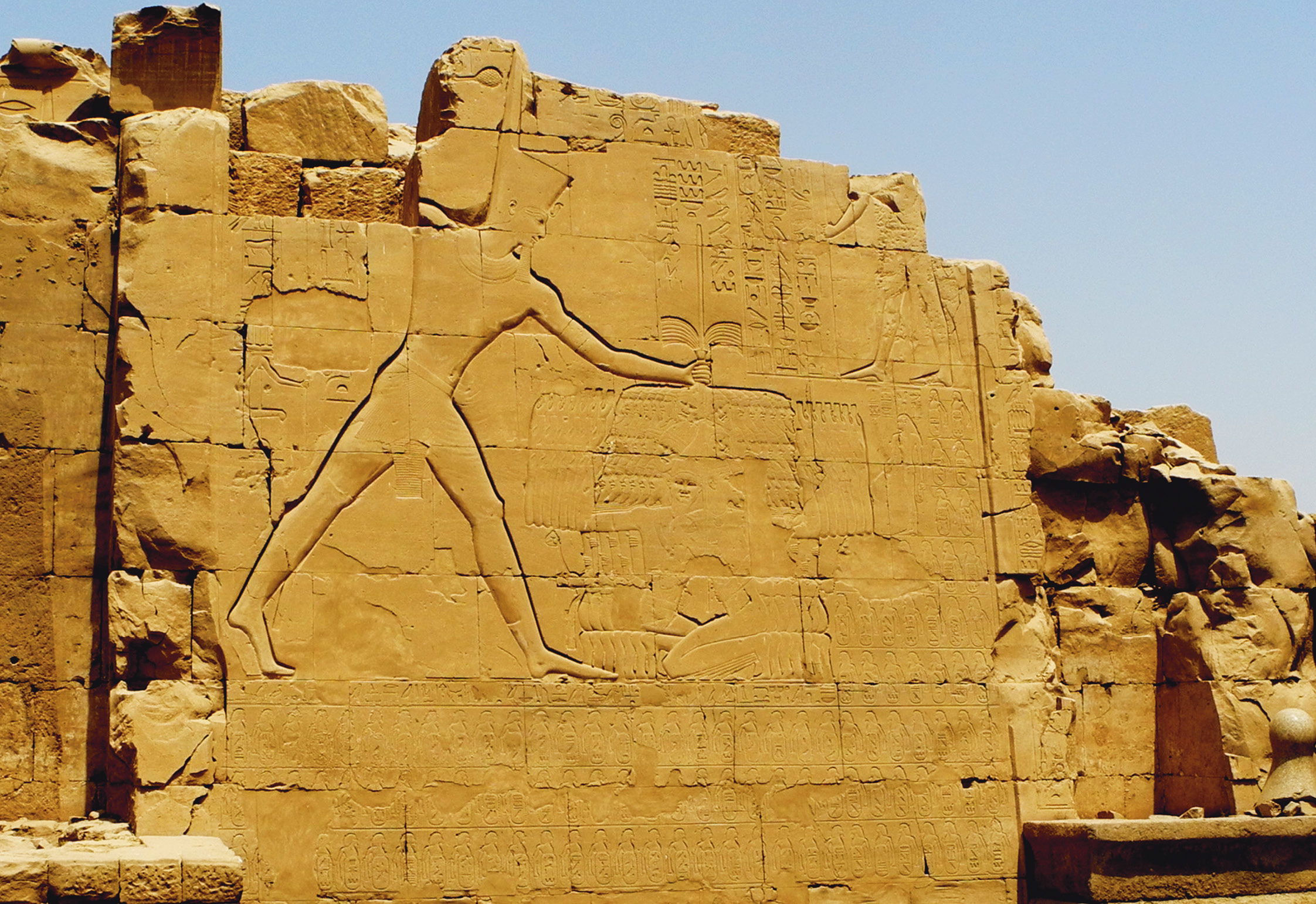 above Thutmose III, wearing the Red Crown of Lower Egypt, smites his enemies, c.1435-1425 BC. This relief on the Seventh Pylon at Karnak is typical in depicting the Asiatic enemies as diminutive and generic, reduced to a collective mass. The relief itemises, among other conquests, the 119 Palestinian cities seized in Thutmose’s earliest
