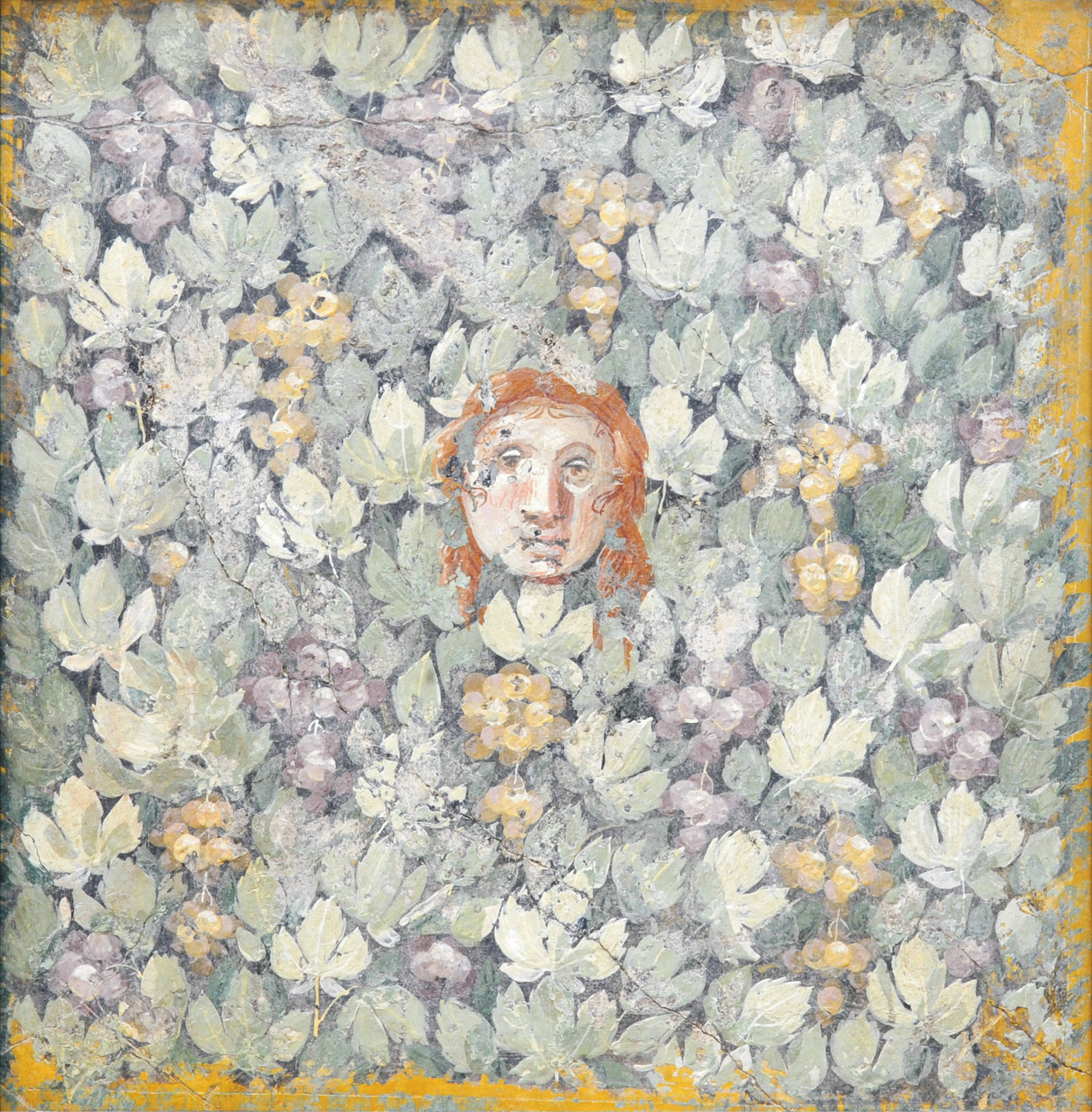 ABOVE Wall painting of a mask surrounded by leaves and grapes from the House of the Mosaic Doves, Pompeii. 20/10 BC,Third Style. Size: 55 x 55cm