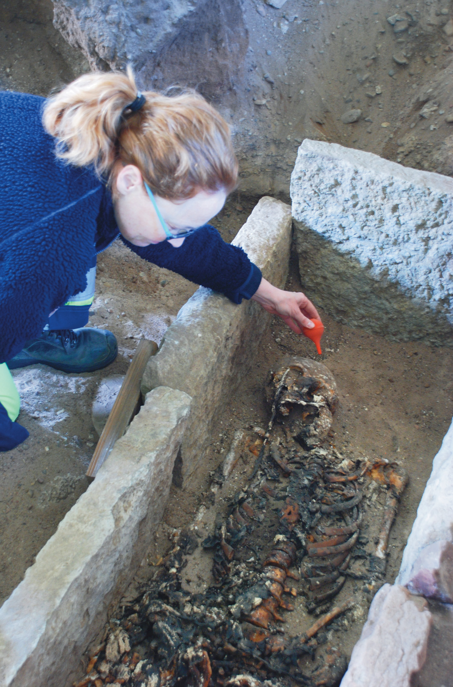 Above Annika Konsmar excavating the grave of the man buried in a prestigious location within Gårdby Church. Various aspects of the treatment of the body had no known local parallels.