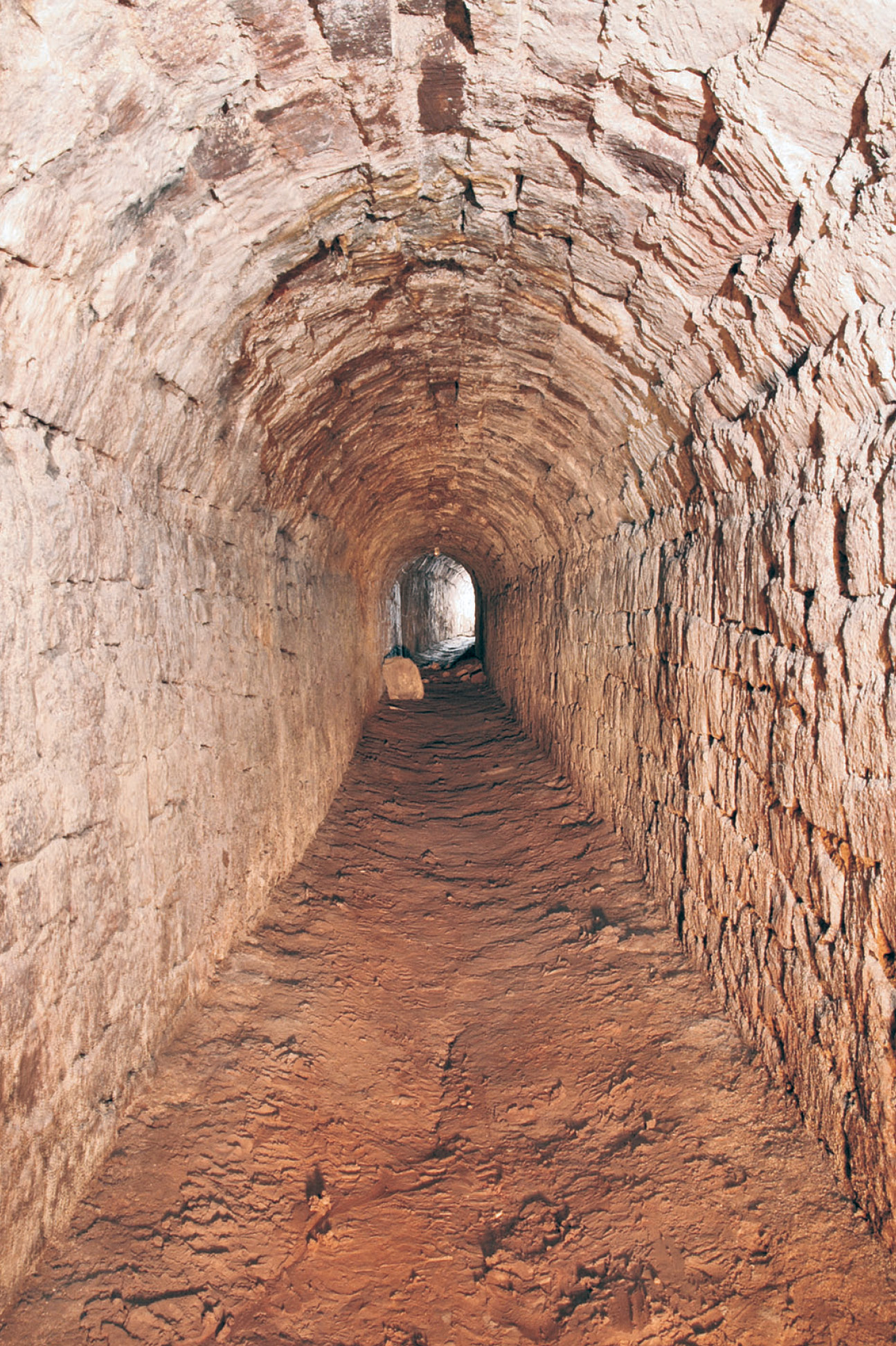 below Looking down Exeter’s 14th-century cathedral passage, showing the chisel-dressing of the volcanic masonry, and the scar of the former lead pipe in the floor of the stone-vaulted tunnel; the pipe was still in place as recently as 1931.