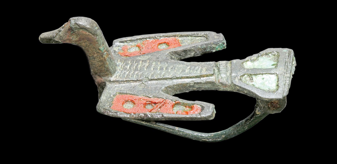 left & below The Corinium Museum holds many artefacts recovered during the excavation of the amphitheatre. Here we see a copper-alloy enamelled bird brooch, as well as a copper-alloy caduceus, presumed to be from a small statue of the god Mercury.