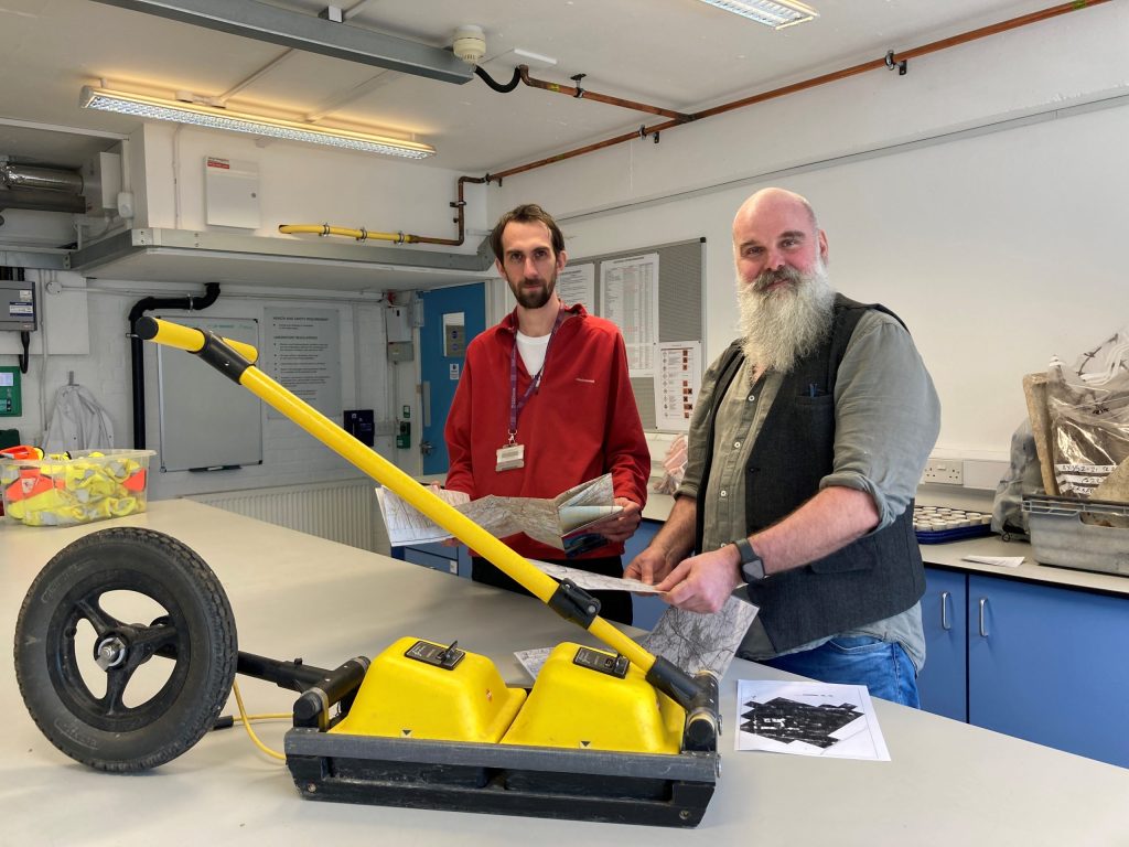David Ashby and Simon Roffey with the Ground Penetrating Radar (GPR) which they hope will allow them to identify the submarine's exact location. Image: University of Winchester.