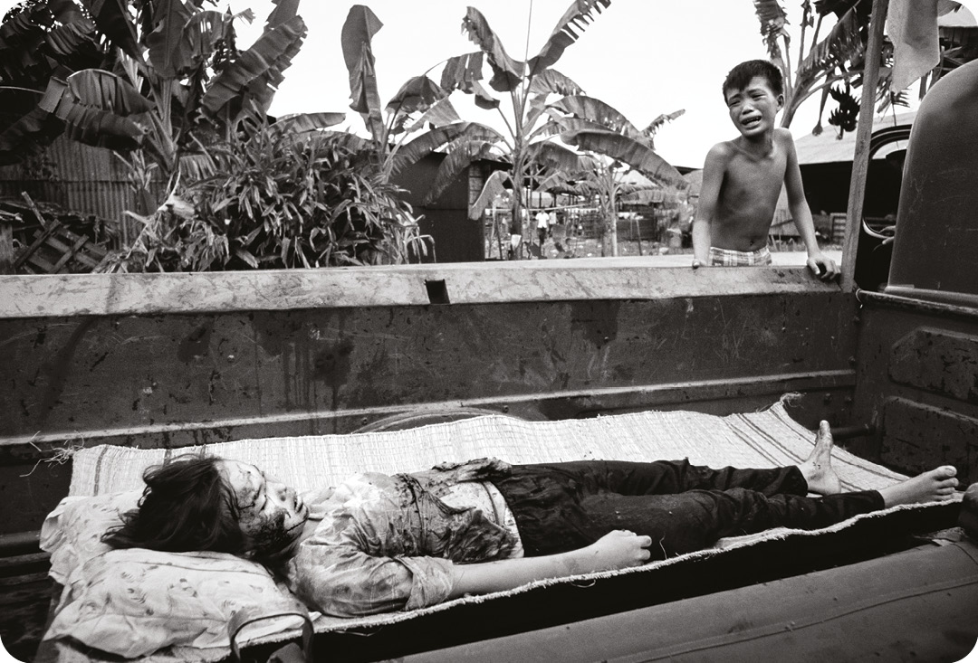 right A 12-year-old girl killed during the May Offensive, also known as ‘Mini-Tet’ the second phase of the Tet Offensive of 1968. below A napalm strike erupts in a fireball near US troops on patrol in South Vietnam, 1966.