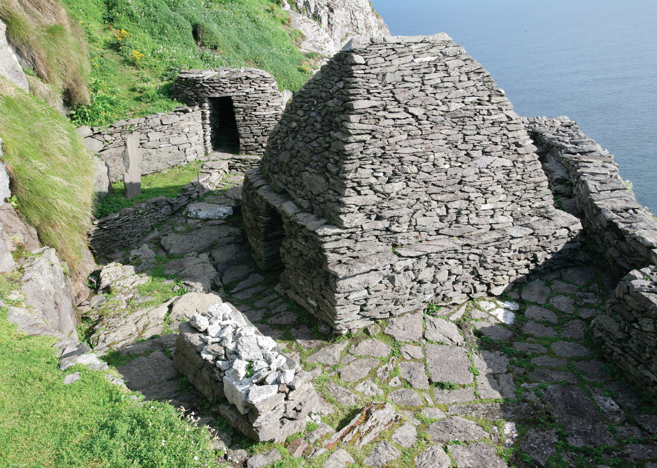 below A view of the smaller oratory terrace with its drystone church, leacht (platform, to the left), and monks’ toilet (top left).