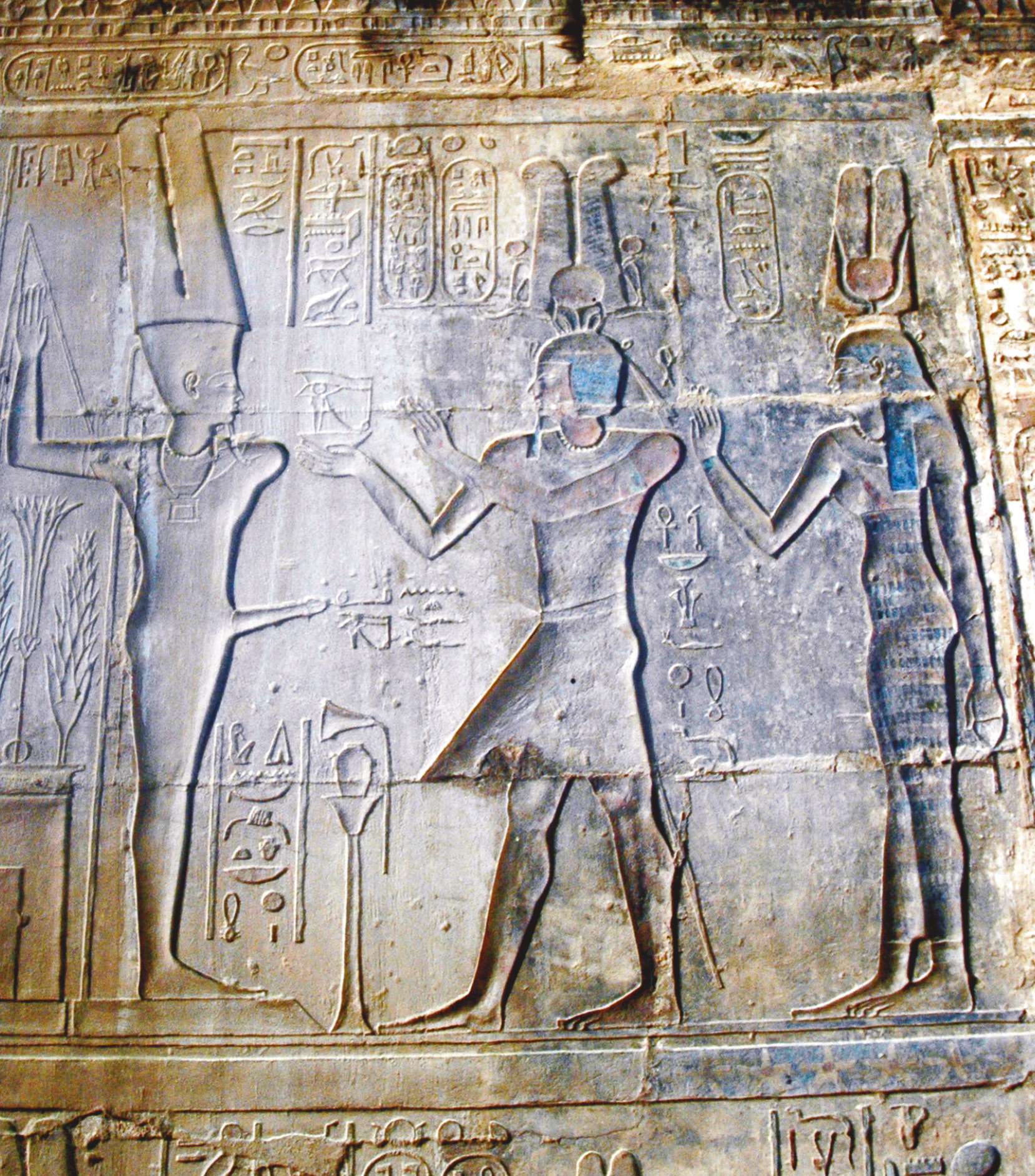 right Ptolemy IV making offerings to Min at the Temple of Hathor at Deir el-Medina.