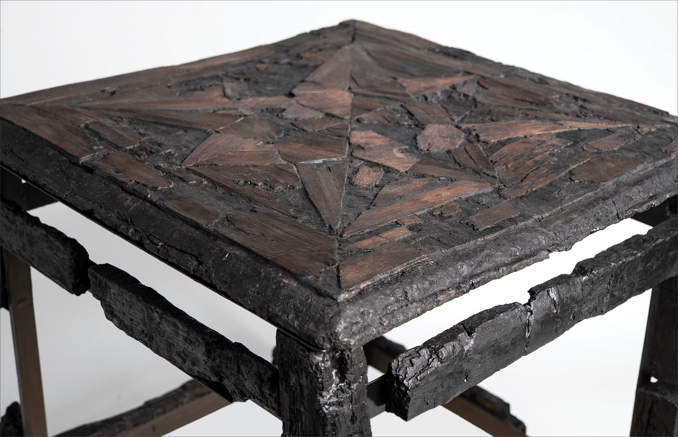 below Detail of a stool with an inlaid star motif achieved by using different woods, 1st century AD. Findspot unknown. Size: 42 x 49cm