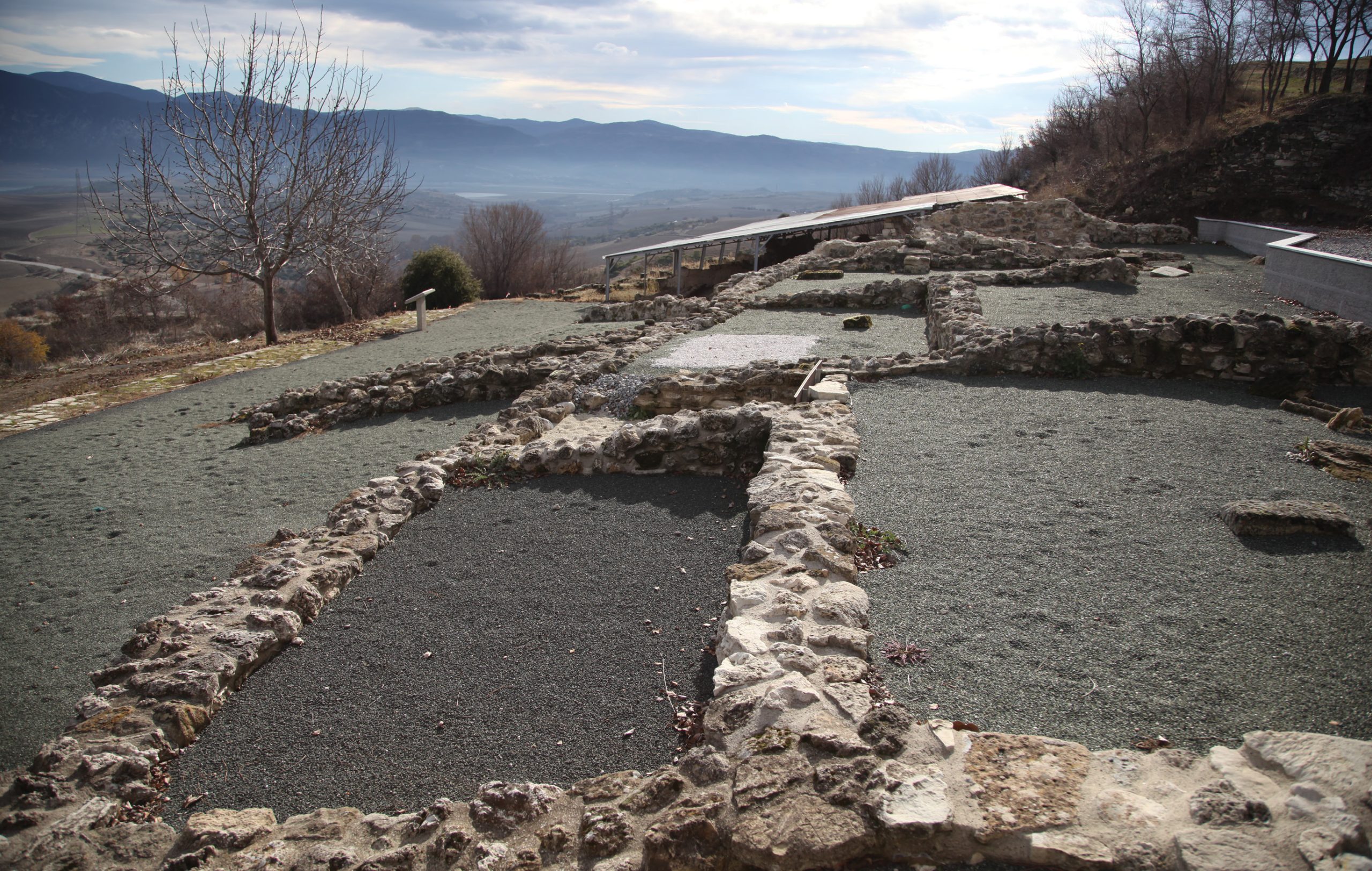 opposite A visit to western Macedonia reveals the world that was unified by Philip II, setting the scene for the extraordinary exploits of his son, Alexander the Great. Here we see one of the earliest examples of a public building from Macedonia. It was found at Aiani, capital of the ancient region of Elimeia, and dates to the 6th-5th centuries BC. right A bronze figurine of a rider found at Aiani. below The spectacular view from the acropolis at Aiani, the ancient capital of Elimeia.