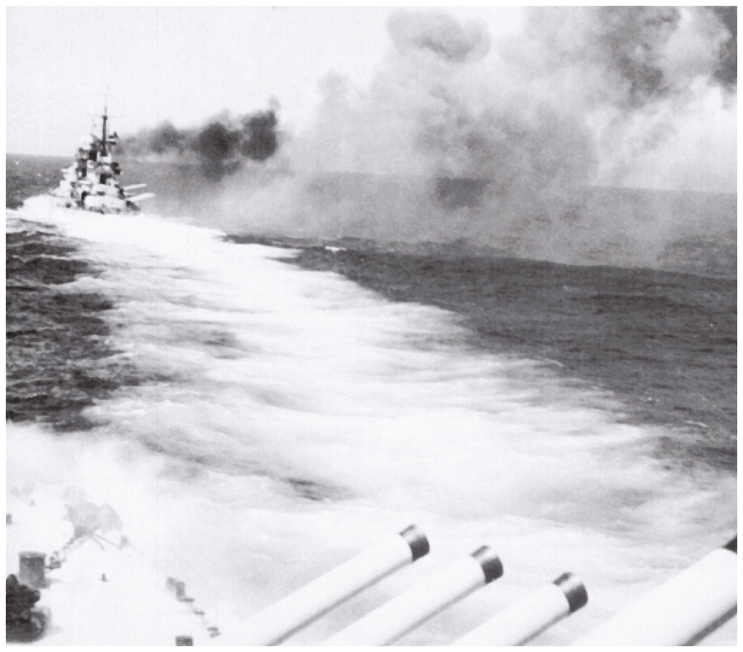 BElow LEFT The Italian battleship Giulio Cesare firing her guns during the Battle of Calabria, an indecisive engagement on 9 July 1940. Although dismissed as an ineffective opponent, the Italian navy proved more than a minor irritant to the British. BELOW An aerial photograph taken on 12 November 1940 shows the aftermath of the daring attack on the Italian naval base of Taranto, home to the fascist battleship fleet.