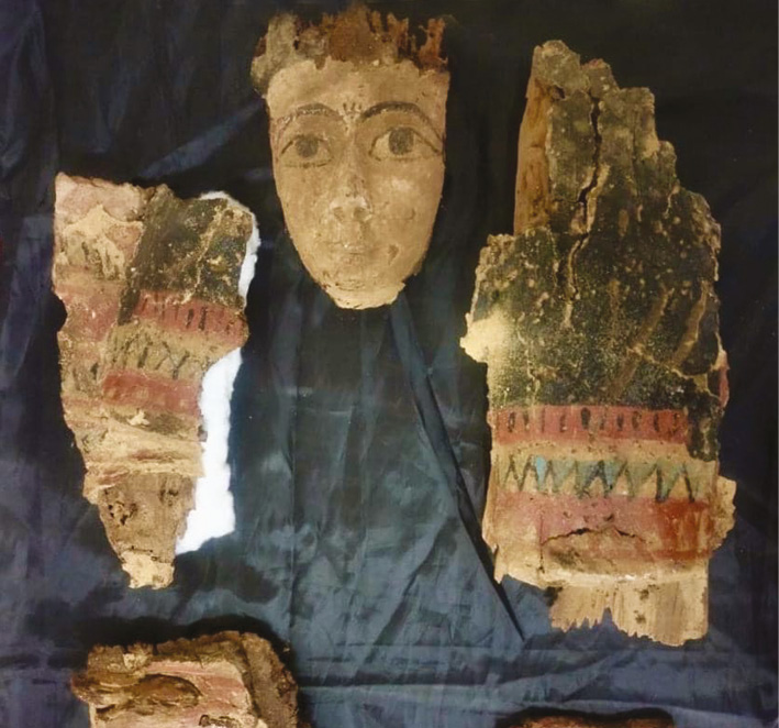top A monk’s room with storage shelf in the newly discovered building at Meir, which dates to the Byzantine Period. above The mummy mask and fragments of chest covering from one of the Late Period burials found at Meir.