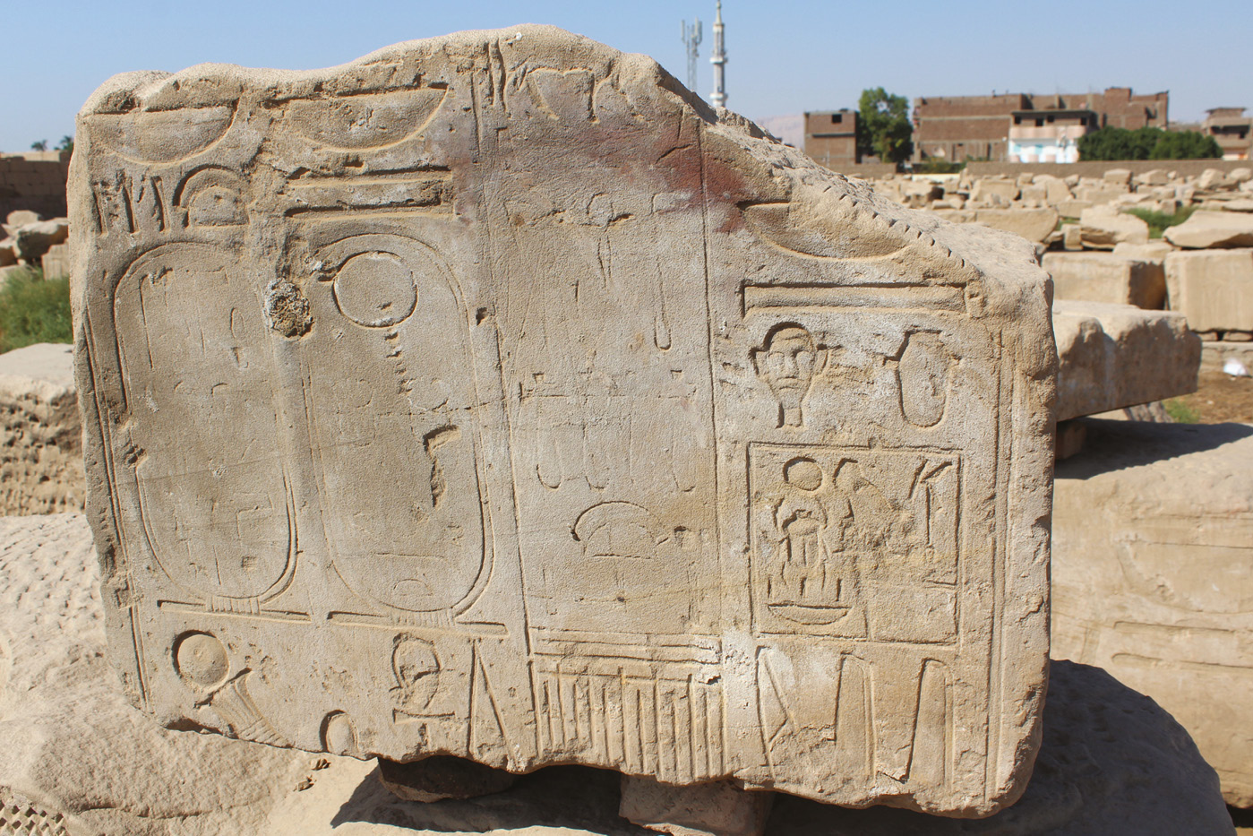 top LEFT A block from Ay and Tutankhamun’s missing temple, found as infill to Pylon II, and now in the Open Air Museum at Karnak. The inscription is the cartouche prenomen of Tutankhamun. ABOVE Another block from Ay and Tutankhamun’s missing temple, also found as infill to Pylon II. The inscription shows the Horus names of both Ay and Tutankhamun, and the start of their Two Ladies names in parallel. LEFT Part of a pier from Tutankhamun/ Ay’s missing temple, now in the Open Air Museum at Karnak. The inscription reads (from right to left): the temple name (Mansion of Nebkheperura (Tutankhamun) in Waset); Ay’s Horus name (Ka Nakht: Tjehen-kha-u); Ay’s prenomen (Kheper-kheper-u-Ra Ir-maat); and Ay’s nomen (It-Netjer Aye Netjer Heqa Waset). The names can still be traced, although they have been